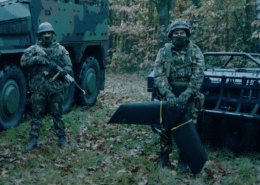 2 soldiers in battle dress and a drone