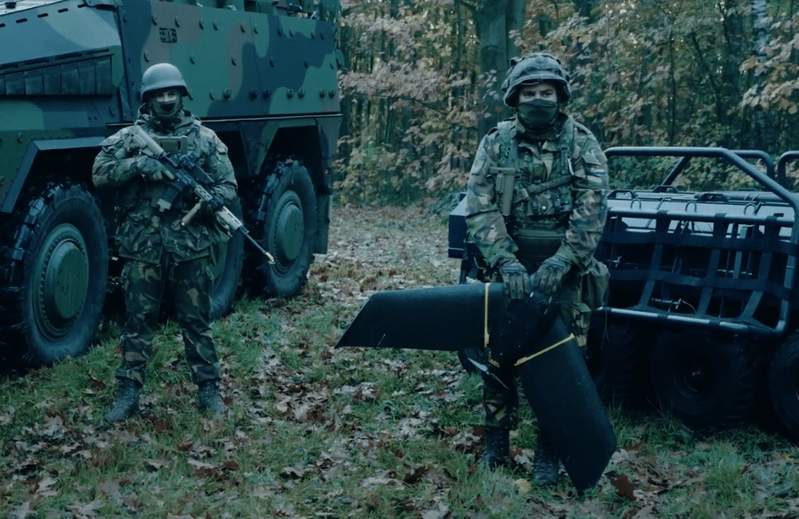 2 soldiers in battle dress and a drone